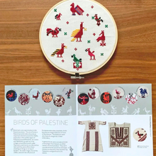 Load image into Gallery viewer, Embroidery hoop with tatreez embroidery design on a wooden surface, accompanied by a pattern sheet titled &#39;Birds of Palestine&#39;.
