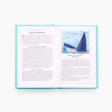 Load image into Gallery viewer, Open pages of The Little Book of Whales showing illustrations and information about whale species, anatomy and marine biology.
