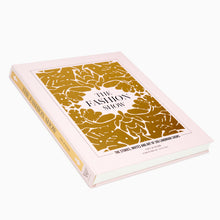 Load image into Gallery viewer, A hardcover book titled &#39;The Fashion Show&#39; with a gold and white floral pattern on the cover.
